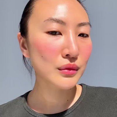 Close-up applying lip + cheek